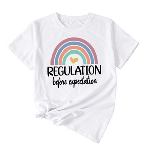 Detail of white cotton T-shirt featuring rainbow print and Regulation before expectation text
