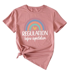 Detail of pink cotton T-shirt with rainbow print and knotted hem for casual styling