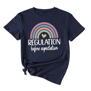 Detail of navy cotton T-shirt featuring rainbow print and decorative hem knot detail