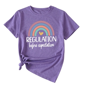 Detail of purple T-shirt with 'REGULATION before expectation' text and side knot hem