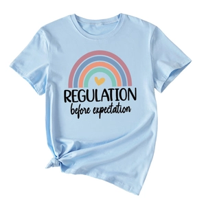 Close-up of light blue cotton T-shirt with rainbow print and knot detail on hem