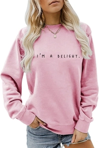 Detailed close-up of pink crewneck sweatshirt with I'M A DELIGHT lettering and ribbed cuffs