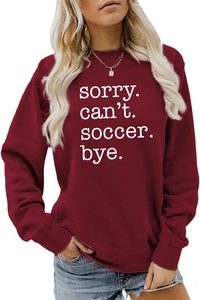 Detail of Sorry Can't Soccer Bye text print on burgundy crewneck sweatshirt fabric