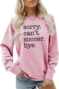 Detail of the Sorry Can’t Soccer Bye slogan print on pink long sleeve sweatshirt