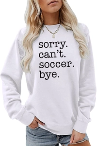 Close-up of Sorry Can't Soccer Bye text print on a white casual long sleeve sweatshirt