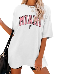 Close-up of white oversized T-shirt featuring pink Miami text and small palm tree print