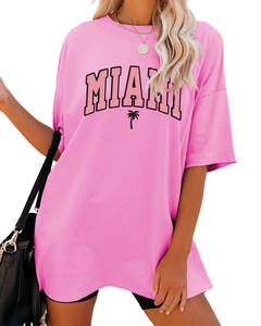 Detail of hot pink oversized T-shirt featuring black MIAMI text and palm tree graphic
