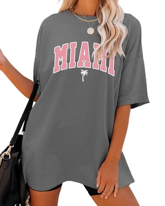 Detail of oversized dark grey Miami t-shirt with pink letters and palm tree print