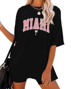 Detail of oversized black t-shirt with pink MIAMI lettering and coconut tree graphics