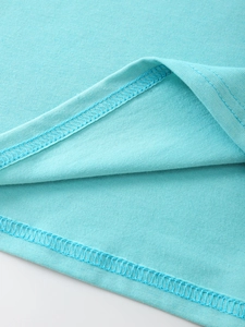 Detail of double-needle stitching on the hem of a light blue cotton knit t-shirt
