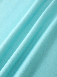 Close-up of light blue cotton fabric texture with fine vertical ribbed knit patterns