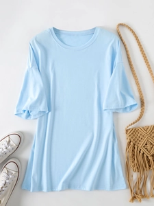 Flat lay of an oversized light blue crewneck T-shirt with summer casual accessories