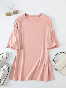 Flat lay of pink crew neck T-shirt with ruffled sleeves and casual accessories