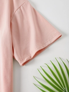 Detail of pink cotton T-shirt sleeve showing professional double-needle stitching quality