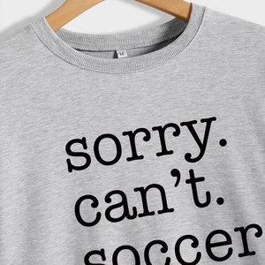 Grey crewneck sweatshirt featuring a bold black sorry can't soccer slogan on the front