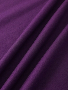 Close-up of premium purple knitted fabric showing soft texture and smooth draped fibers