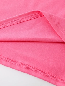 Close-up of double-needle overlock stitching on vibrant pink cotton knit t-shirt