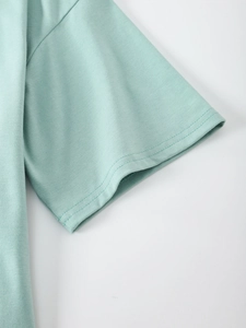 Detail of mint green t-shirt sleeve with high-quality double-needle stitching and fabric