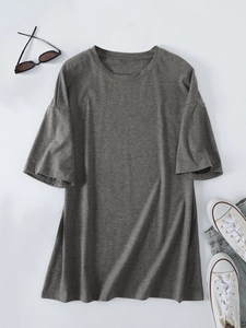 Flat lay of an oversized dark grey heathered T-shirt with casual styling accessories