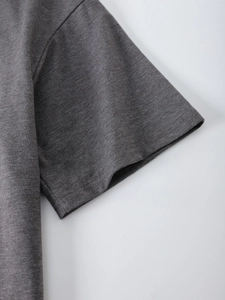 Close-up of dark grey T-shirt sleeve with durable double-needle stitching and knit texture