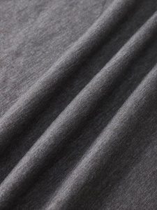 Macro detail of charcoal grey heather knit fabric showing texture and soft drape of the T-shirt