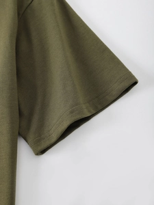Detailed view of olive green cotton t-shirt fabric texture and double-stitched sleeve cuff