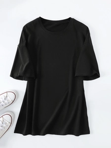 Flat lay of a plain black oversized crew neck T-shirt with soft cotton fabric texture