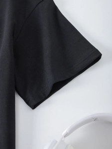 Detailed close-up of double-stitched sleeve cuff on women's black cotton t-shirt