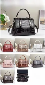 Detail view of crocodile pattern handbag showing multiple colors and internal compartments