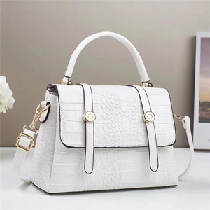 Elegant white crocodile pattern backpack for women featuring luxury gold hardware