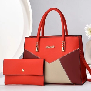 Detail view of red contrast color tote and clutch set with textured PU leather and V-stitching