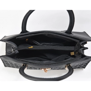 Top view of black tote bag showing organized interior compartments and gold zipper details