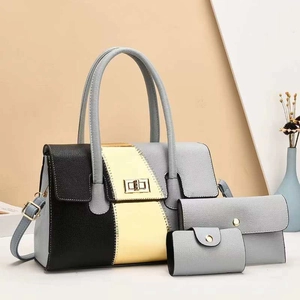 Detailed set of a large tote, long wallet, and small card holder in grey and gold faux leather