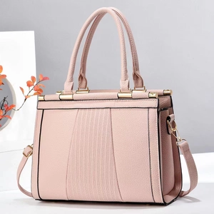 Detail of light pink tote bag featuring lychee grain leather and vertical striped embossing