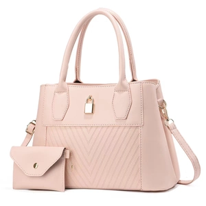 Detail of pink tote bag with V-shaped stitching and gold lock closure detail