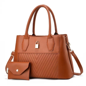 Brown quilted tote bag with gold lock detail and matching small pouch set