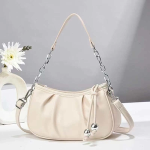 Chic cream white pleated hobo bag with silver chain strap and decorative sphere charm