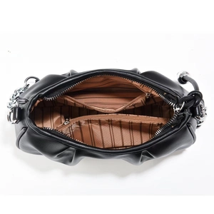 Top view of black pleated dumpling bag showing three compartments and striped lining