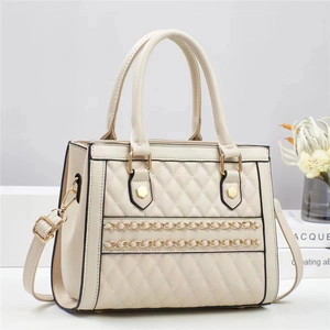 Elegant cream quilted handbag with gold chain detail, crossbody style for women