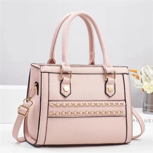 Pink lychee texture handbag with gold chain detail and adjustable shoulder strap