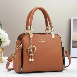 Brown lychee texture handbag with golden hardware and heart pearl pendant detail