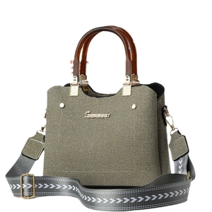Chic beige textured canvas handbag with brown acrylic handles and patterned shoulder strap