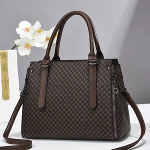 Detailed close-up of a retro brown crossbody bag with beige diamond lattice patterns