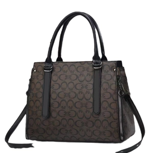 Women's dark brown crossbody bag with classic pattern print and circular top handles