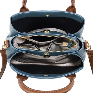 Top view of blue crossbody bag showing spacious interior compartments and striped lining