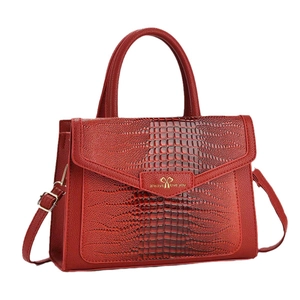 Red crocodile texture shoulder bag with heart hardware and adjustable strap