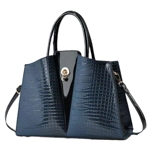 Navy blue crocodile embossed crossbody bag with black patent leather and gold clasp