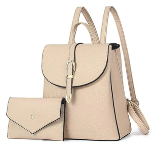 Detail of beige litchi grain leather backpack and matching envelope clutch with gold buckle