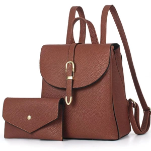 Detail of brown litchi pattern leather backpack with matching envelope wallet set
