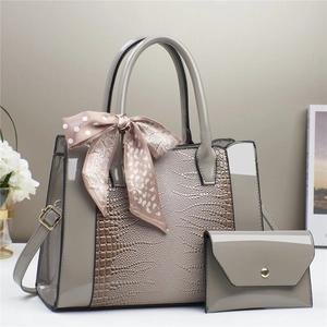 Gray-taupe large tote with matching clutch and silk scarf detail on handles